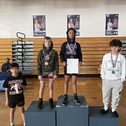 A wrestler at the top of the podium